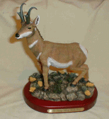 Figurine featuring a pronghorn Antelope standing in a rocky area